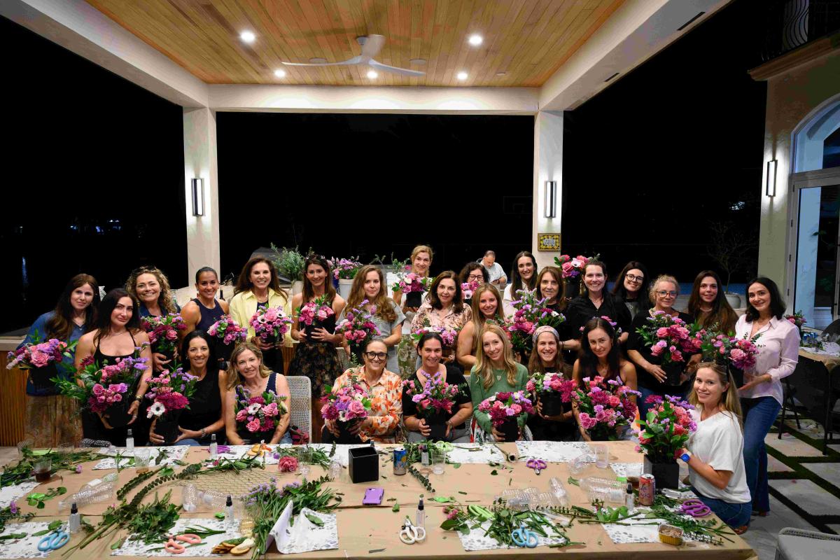 Women gathered with their floral arrangements at Chabad Chai Center’s Shavuot event